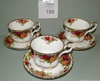 Three Royal Albert Old Country Roses bone china cups and saucers displayed together showing floral pattern and gold trim.