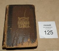 Front cover of cloth hardcover botanical manual with gilt title ‘Robinson’s New Family Herbal’ alongside lot tag