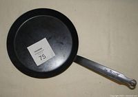 Top view of the de Buyer carbon steel pan showing the cooking surface with a MaxSold lot number placed inside.