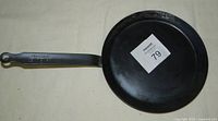 Top view of de Buyer carbon steel crepe/omelette pan showing flat cooking surface and handle.
