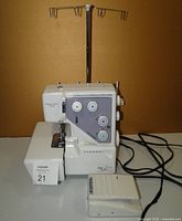 Front view of Janome serger with spool stand