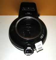 Top view of the black T-Fal Actifry Genius XL air fryer showing the closed lid with transparent window and digital control panel.