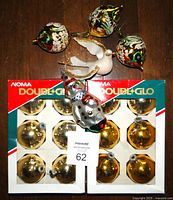 Two boxed sets of gold Double-Glo mercury glass ornaments with additional vintage ornaments laid out, showing all items included in the lot