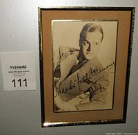 Frontal view of the signed black and white Bob Hope publicity photo in gold-tone matted frame showing signature and subject.