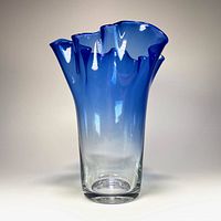 Front view of the blue blown glass vase showing clear to blue gradient with ruffled top.