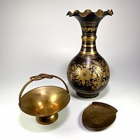 Full view showing all three items: the etched brass table vase, basket-style dish with knotted handle, and pocket change tray.