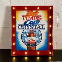 Full view of the illuminated bar sign showing the Labatt's Crystal bottle and text 'Hot Times Cold Crystal' with 16 lit bulbs around red frame.