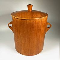 Front view of wooden teak ice bucket showing overall shape, side handles, and wood grain