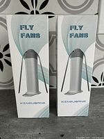 Front view of two new Kingubang Fly Fans in packaging, showing product name and brand.