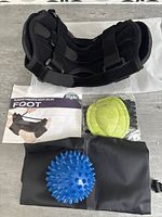 Black adjustable plantar fasciitis night splint with straps and foam padding, shown from side