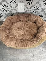Top view of the pet bed showing plush furry beige interior and suede-like outer sides.
