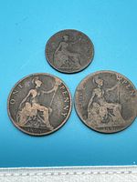 Three copper coins on blue background, including 1896 Half Penny, 1898 One Penny, and 1901 One Penny coins, all with seated Britannia design.