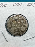 Reverse side of the 1910 Canadian 25 cents silver coin showing denomination '25 CENTS', country 'CANADA', year '1910' with surrounding maple leaves and wreath.