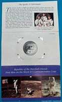 Photo showing informational card about Apollo 11 astronauts and moon landing anniversary included with the coin.