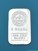 Front view of the 5 gram Monarch Precious Metals silver bar showing the logo, weight, and purity markings clearly.