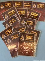 Photo showing 14 brown coin collector books with titles for Canadian 50, 25, 10, 5 cents and cents coins, date ranges from 1858 to 1987.