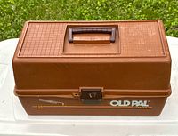 Closed view of brown Old Pal Custom fishing tackle box with handle and lock