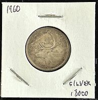 Photo of the reverse of the 1960 silver coin showing the caribou design.
