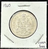 Reverse side of the 1960 Canadian 50 cent coin showing the Canadian coat of arms, year 1960, and denomination 50 cents. Marked 80% silver on the card holder.