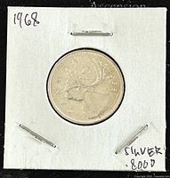 Reverse side of the 1968 Canadian 25 cent silver coin showing caribou design, date and silver content mark.