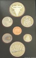 Full set of seven Canadian proof coins in black display case, showing obverse with Queen Elizabeth II and various reverse designs including buffalo skull and canoe.