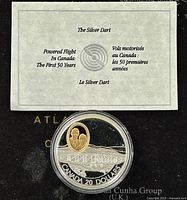 Silver Dart coin with packaging certificate showing aviation theme and bilingual text.