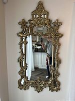 Full view of the gold ornate wall mirror showing its size and intricate frame design.
