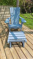 Front view of chair and footstool on wooden deck