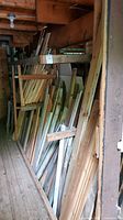 Wide view showing numerous wood pieces of assorted sizes stacked vertically in a 10 foot section.