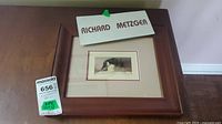 Framed signed and numbered print of a goose at rest by Richard Metzger, with signature visible on mat above the frame.