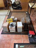 Overview of all items included in the lot: micro HiFi system components, speakers, CDs, CD racks, and soft cases on a patterned rug.