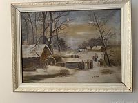 Framed oil painting showing snow-covered rural winter landscape with houses, trees, and two figures. Signed A. J. Ross.