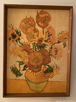 Full front view of framed art print showing sunflowers in a vase, signed by Vincent van Gogh.