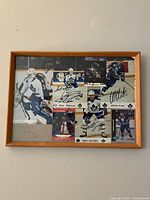 Wooden framed collage with photos and hockey cards signed by Toronto Maple Leafs players and coach.