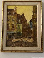 Front view of the vintage oil painting showing Paris street scene in wood gold frame with fabric liner.