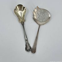Top view of two sterling silver spoons, displaying design details