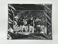 Full view of the 16x20 black and white print of San Francisco Giants players celebrating on the field, with black matte border and plastic cover.