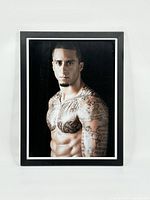 Front view of the framed photographic portrait of Colin Kapernick showing a shirtless Kapernick with tattoos.