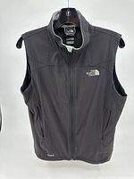 Front view of gray sleeveless vest with full front zipper and The North Face logo on chest