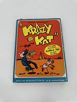 Front cover of Krazy Kat comic book with bright orange background and characters Krazy Kat and Ignatz Mouse.
