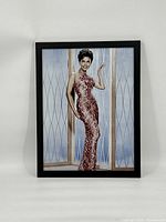 Frontal photo showing framed Lena Horne print in elegant red patterned gown.