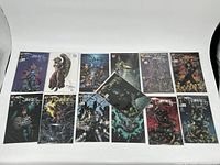 Photo showing all 13 comic books arranged in a row, front covers visible.