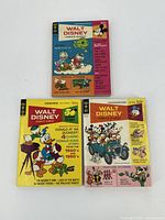 Top view photo of the three Gold Key Walt Disney Comics Digest comic books showing front covers with colorful Disney characters.