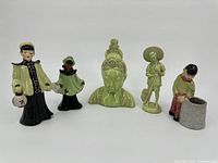 Group of five Asian figurines and statues arranged in a row