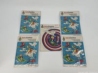 Five AstroComics comic books arranged on a white background, wrapped in plastic, showing colorful blue and white covers with cartoon characters and American Airlines branding.