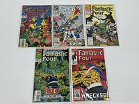 Five Fantastic Four comic books laid out showing front covers with varied cover art and characters.