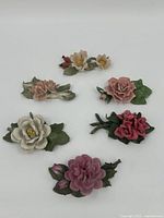 Overview of all six porcelain flower decoratives showing different colors and shapes.