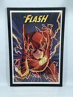 Front view of framed print of The Flash in red suit running with yellow lightning effects on dark background