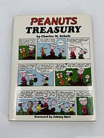 Front cover showing the title 'Peanuts Treasury' with Peanuts comic strip panels and the author's name Charles M. Schulz.