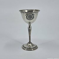 Front view of the sterling silver chalice showing the medical emblem with caduceus.